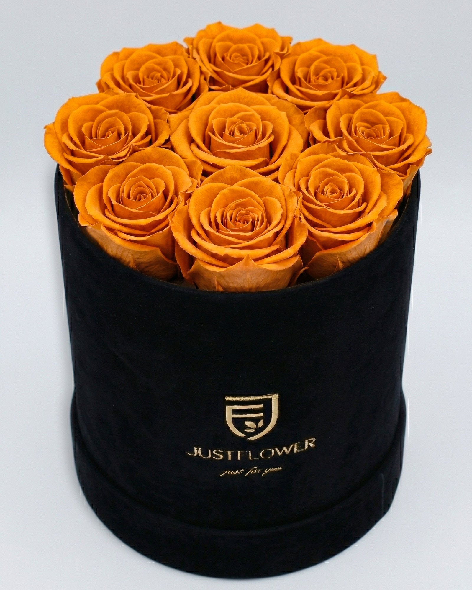 Rosenbox Rund Medium Schwarz Velvet mit orangefarbenen Infinity Rosen – lebendige und kontrastreiche Geschenkidee