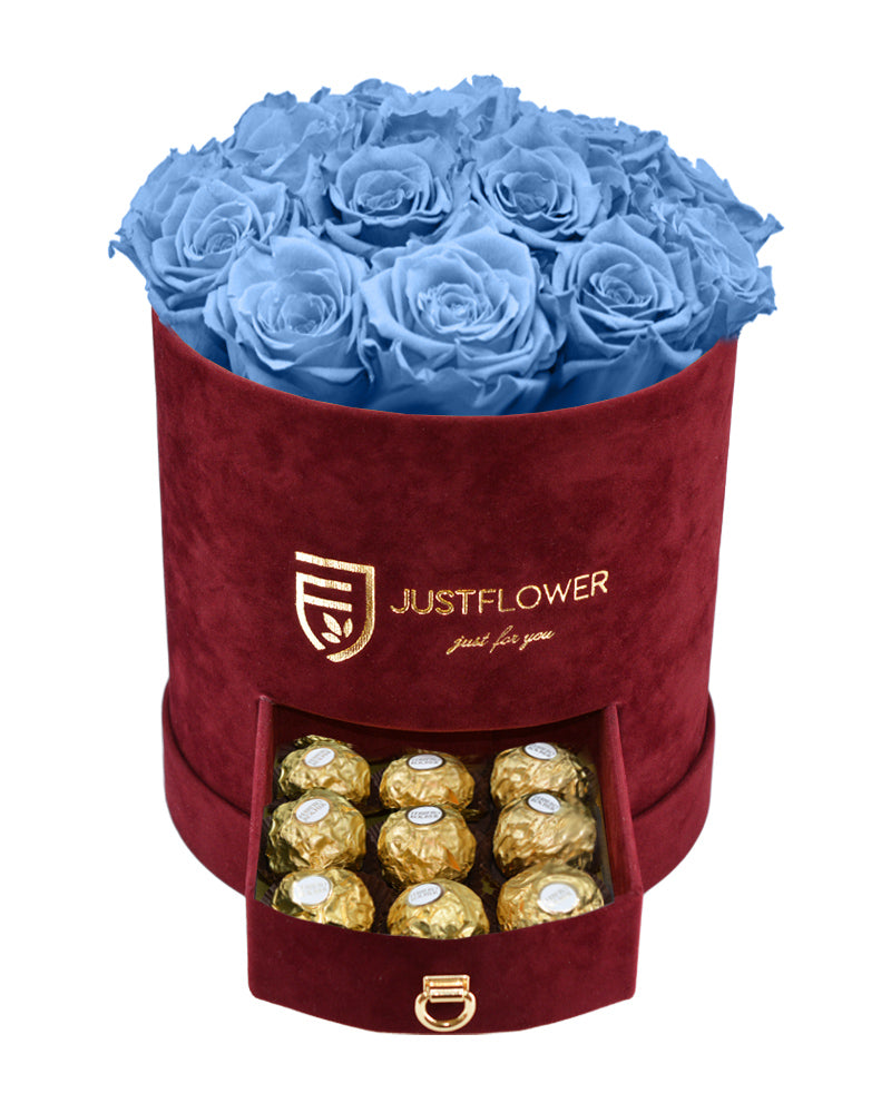 Rosenbox mit hellblauen Infinity Rosen – Burgunderfarbene Rosenbox mit konservierten ewigen Rosen und einer Schublade voller Ferrero Rocher. Bestellen Sie diese luxuriöse Rosenbox bei JustFlower.ch für ein perfektes Geschenk.